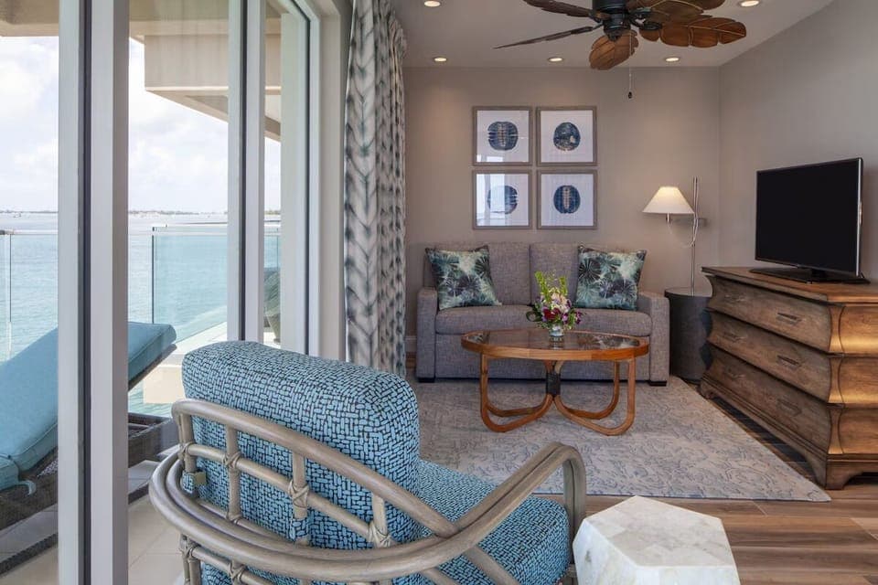 Lounge together while sunlight pours in from the balcony.