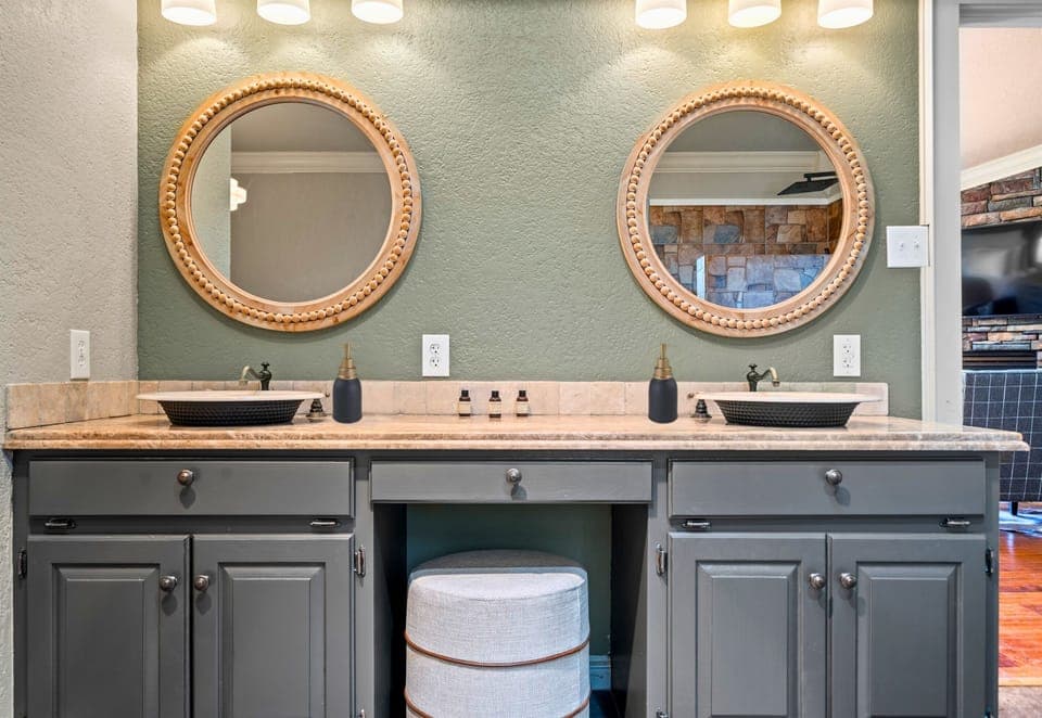 Double vanities make mornings easy in this well-appointed bathroom, designed with convenience and style in mind.