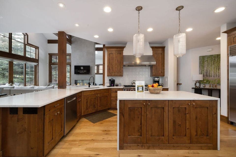 Large kitchen with wood cabinets and white countertops.
