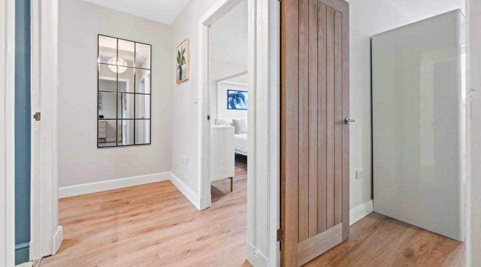 Bright and modern upstairs landing leading to beautifully designed bedrooms. A perfect blend of style and comfort, with warm wooden flooring, elegant décor, and a spacious feel to make your stay even more enjoyable.