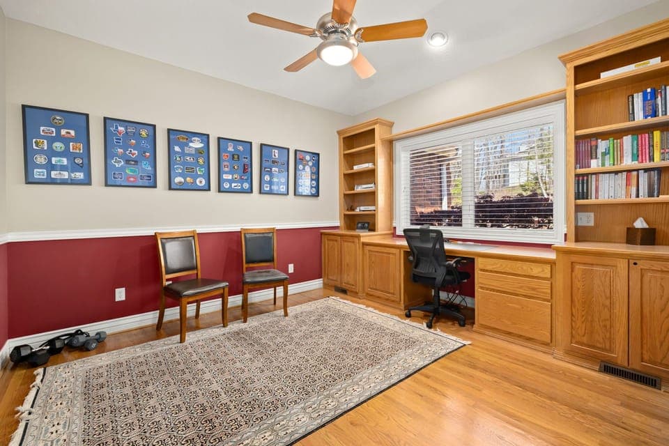 A closed-off office space with books, offering a quiet and cozy environment for reading, working, or studying.