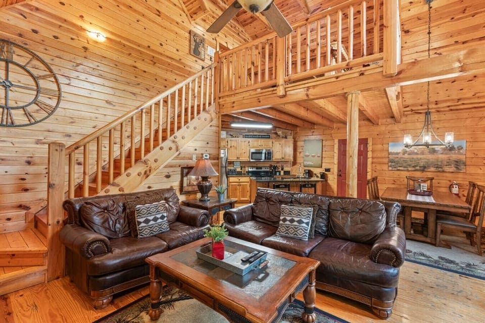 Relax in the inviting living room with plush leather seating, cozy fireplace, and large Smart TV—perfect for movie nights or quiet mornings.