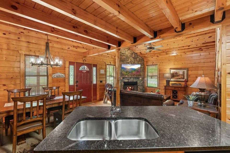 From the center island, take in the beautiful flow of the space, with direct access to the living room, dining area, and the warm glow of the fireplace.