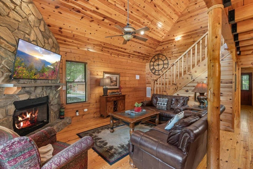 Enjoy a warm welcome the moment you enter—this open-concept space features soaring ceilings, a stone fireplace, and handcrafted wood finishes throughout.