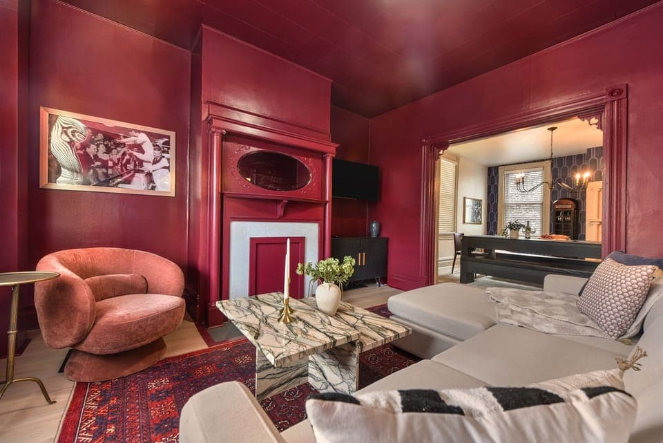 A moody maroon living room escape inspired by the secret lounges of the 1920s