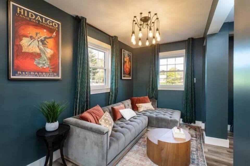 Moody lounge space w/ velvet seating, bold artwork & warm ambient lighting