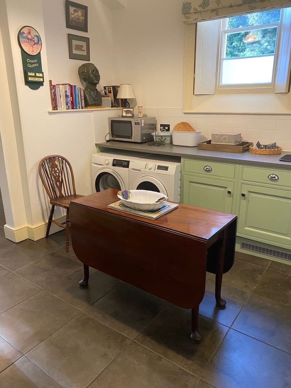 Utility area connecting to the main kitchen with small table to seat four