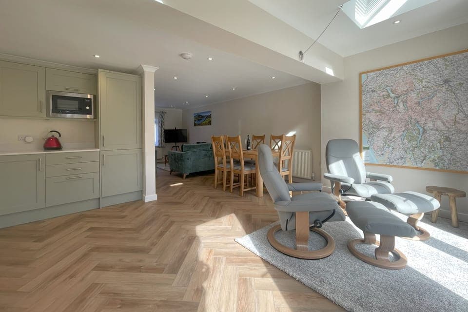 the large open plan living space with living room, kitchen and dining room.