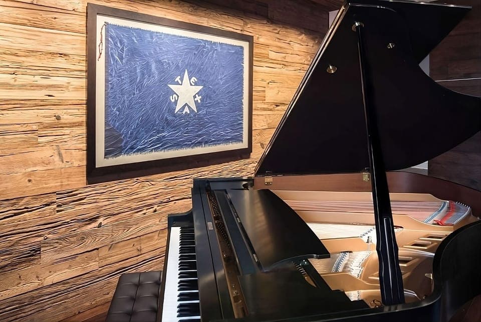 Play a few notes on the gleaming grand piano corner.