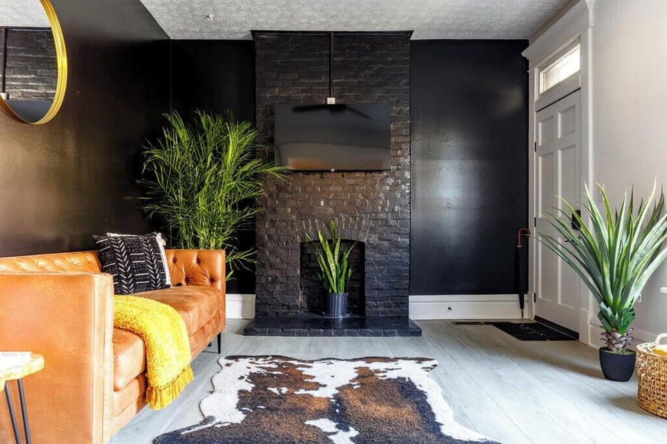 Kick back in our cozy Columbus Airbnb living room featuring a plush couch, modern decor, and a smart TV for your entertainment! Perfect for relaxing or gathering with friends 