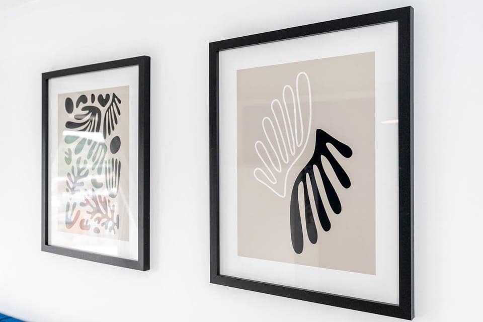 Black and white pictures in the main bedroom with ensuite.