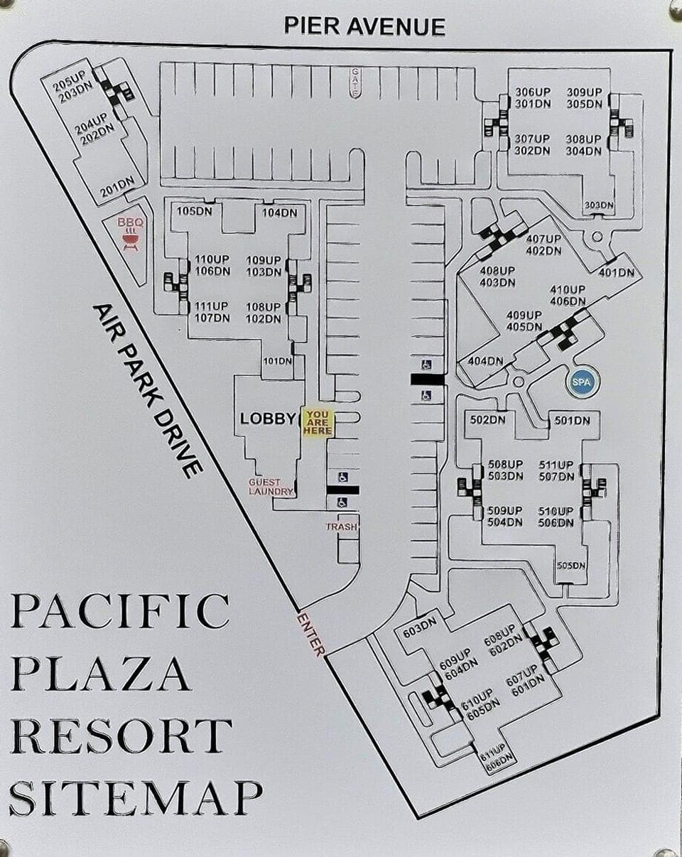 Pacific Plaza Resort offers coastal-style buildings and shared amenities, including a laundry center, hot tub, and barbecue area with picnic tables.