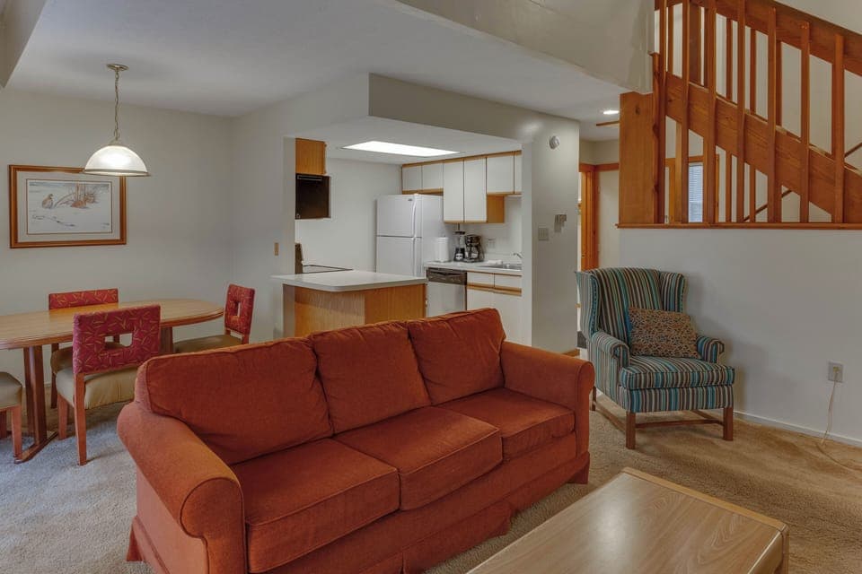 Open-concept living area with warm wood tones, a fireplace, and comfortable seating—perfect for relaxing after a day outdoors.