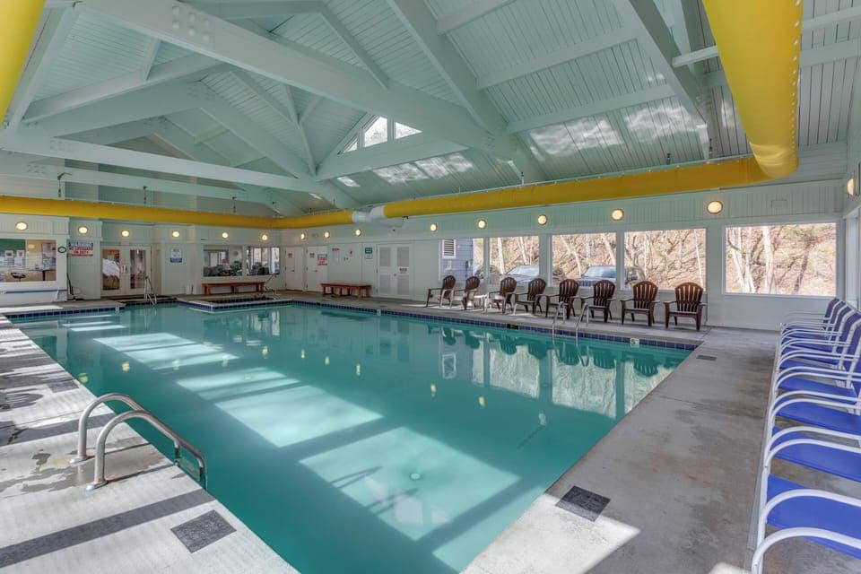 Enjoy year-round relaxation at the resort’s shared indoor pool, complete with lounge chairs and a bright, airy atmosphere.