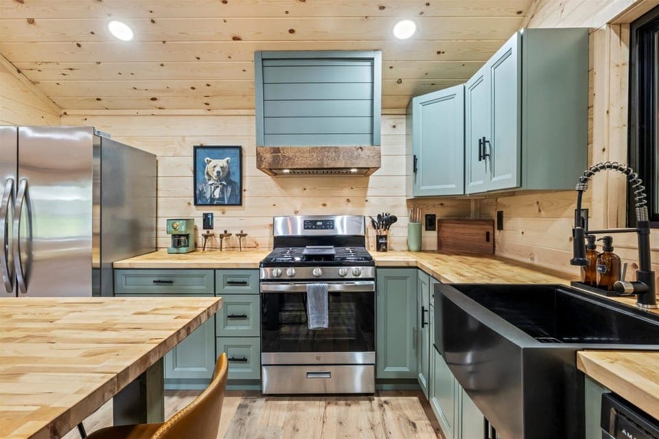 Fully equipped kitchen with warm wooden cabinetry and modern appliances.
