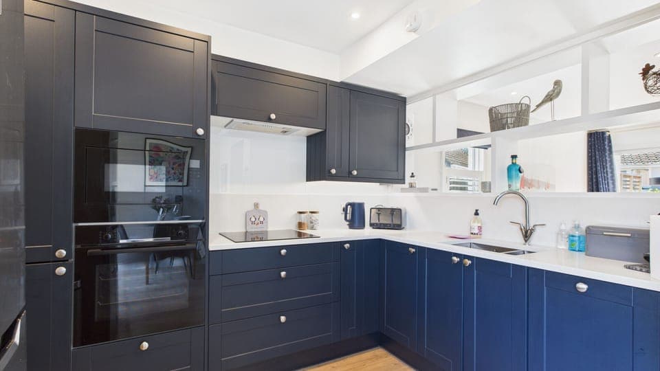 A modern kitchen fully equipped for self-catering, featuring an oven, microwave, and dishwasher.