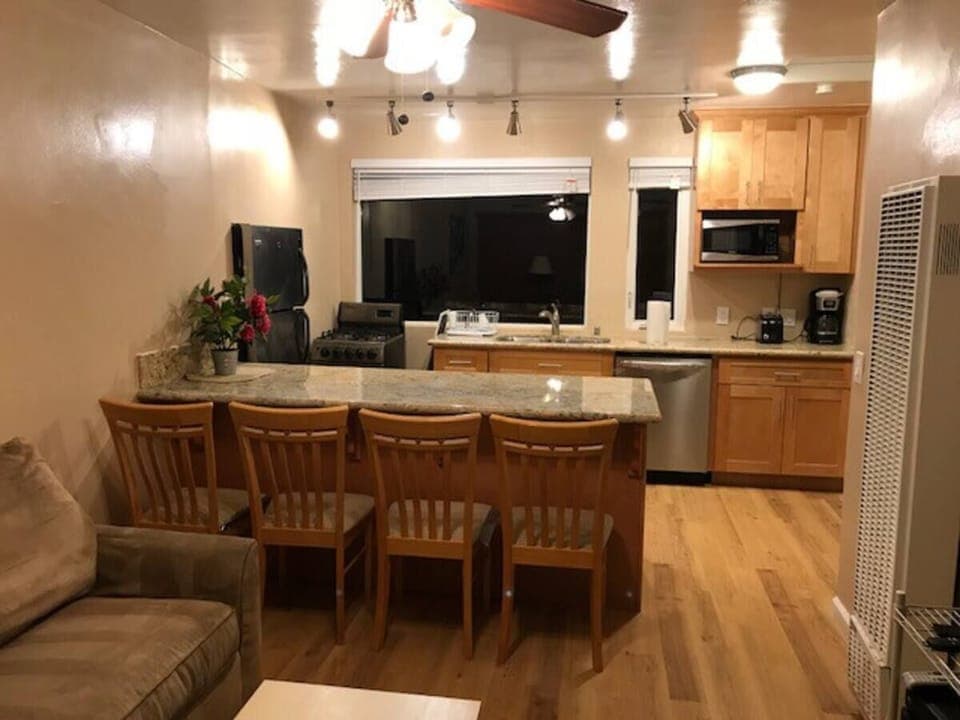 Portion of living room.  Has newer sleeper sofa not pictured & TV on right wall.