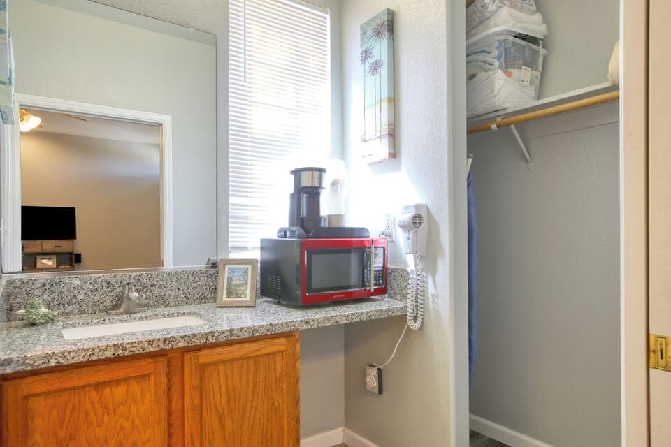 Compact kitchenette has a mini fridge, microwave, and kcup coffee maker—perfect for quick beachside bites.