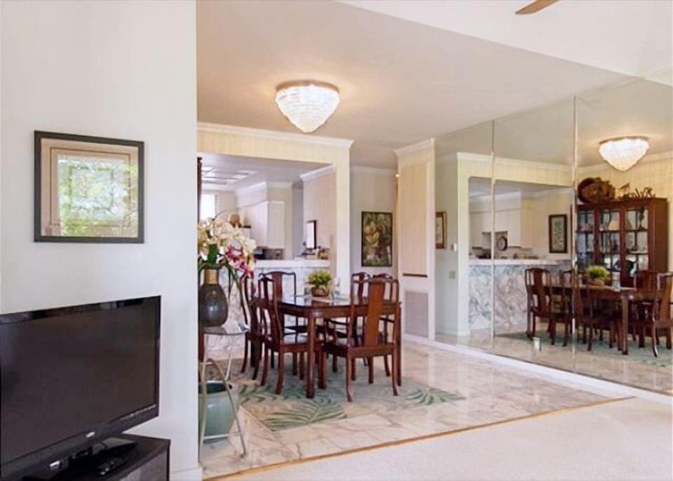 Elegant dining area flows into a well-lit living space, perfect for family dinners.