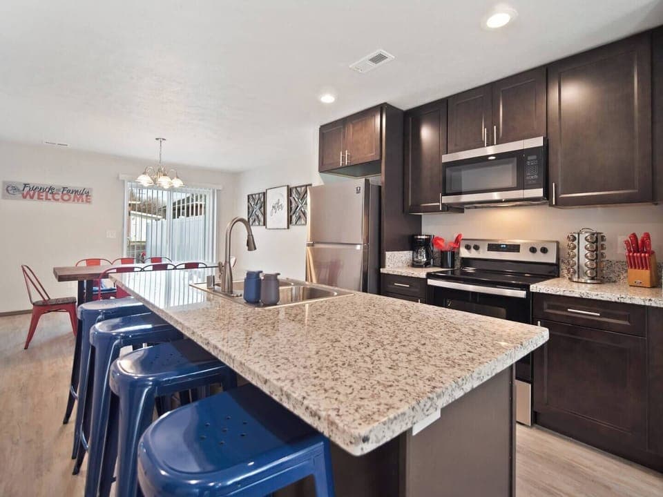 Full kitchen with sink in-island and bar seating. 