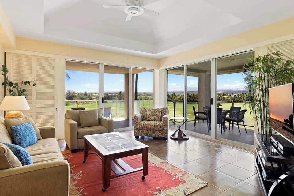 Stretch out in this breezy, sun filled lounge with panoramic fairway views and sliding doors to paradise.