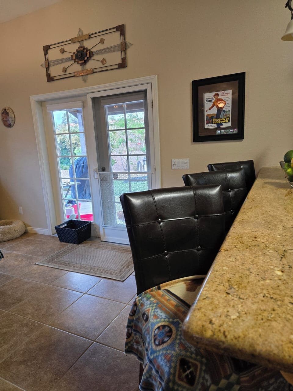 Kitchen bar with 3 comfy high chairs.  Exit to the back patio.