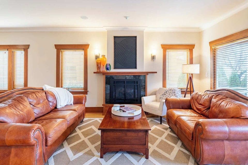 Living room with leather couches and cozy gas fireplace.