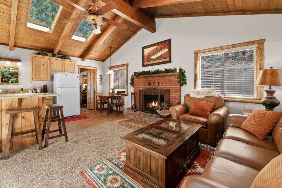 Warm, wood-beamed living room w/ comfy seating & rustic details made for relaxing together.