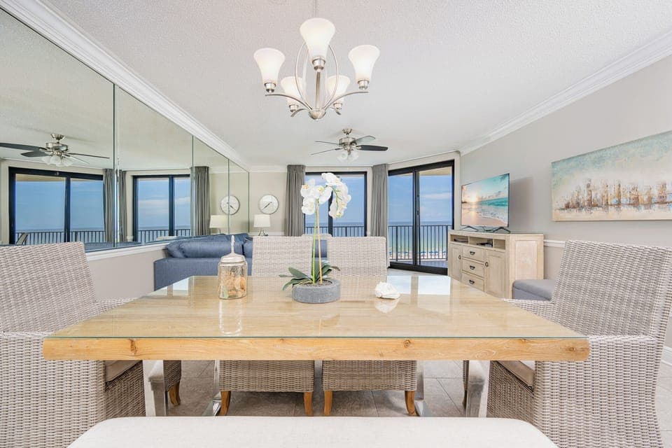 Dine at the stylish table while enjoying views through expansive windows that invite natural beach light into the space