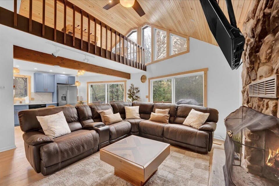 Large Open Living Room with Fireplace and Forest Views