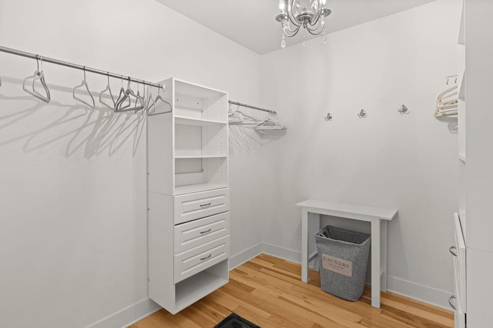 The primary bedroom features a king bed, TV, walk-in closet, additional sitting area and an ensuite bathroom.