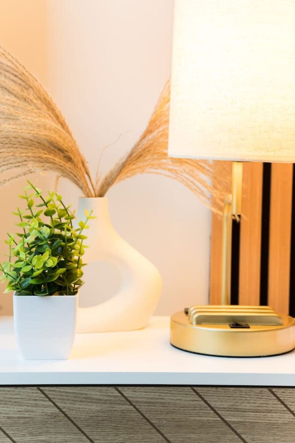 The lamps have outlets for conveniently charging your electronic devices. Lamp base has a stand for two phones while charging