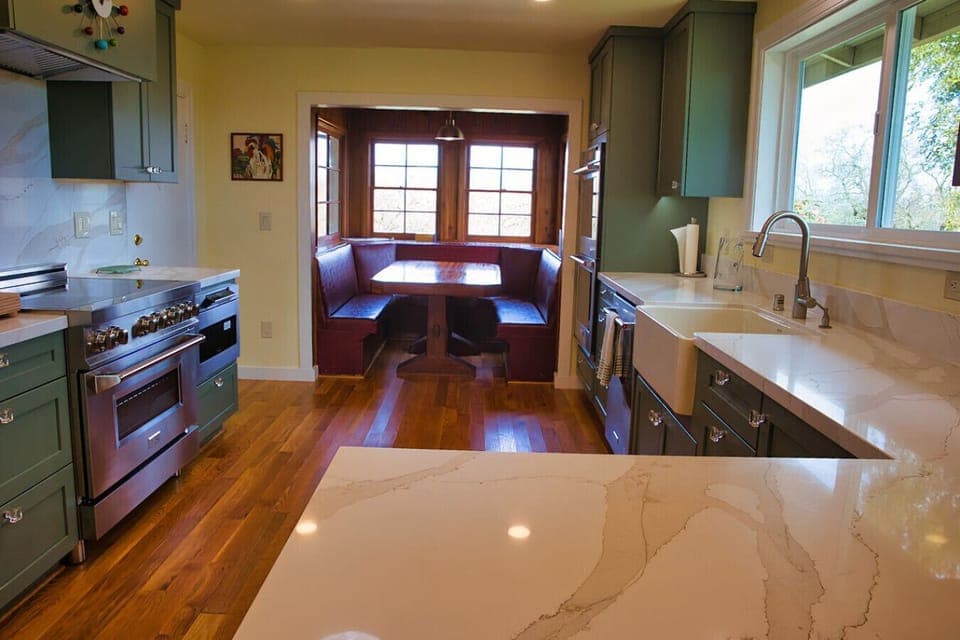 Find comfort in the kitchen with the booth like dining table and stunning modern appliences