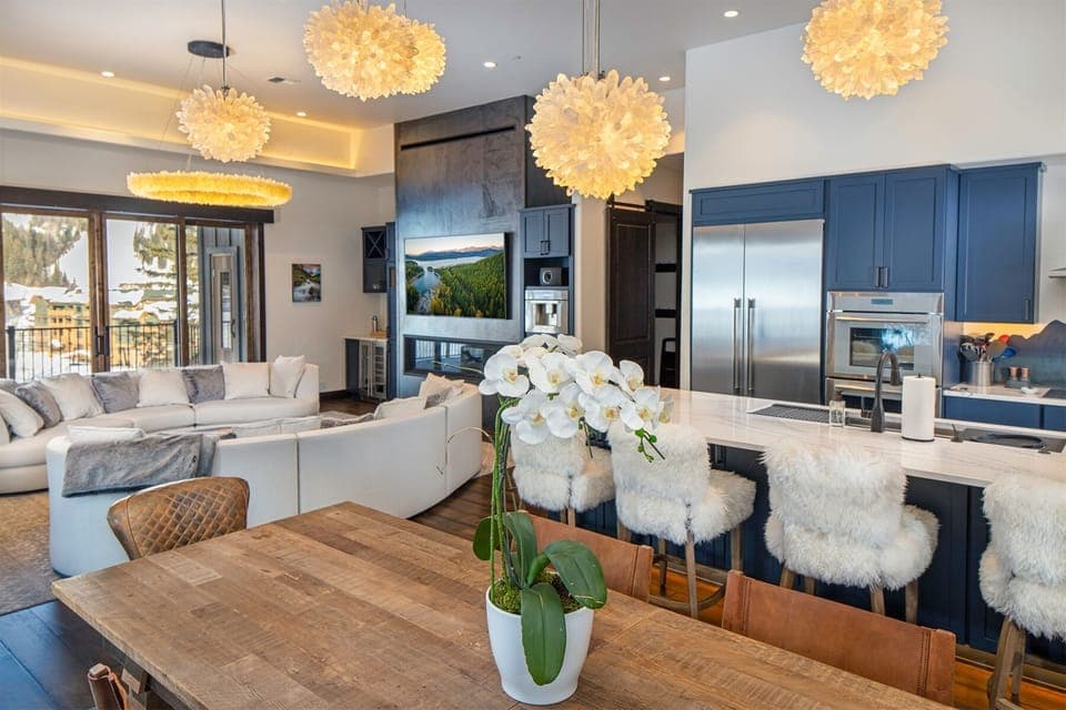 The modern open concept kitchen, dining area & living room provide plenty of space for your group to connect | Main Level