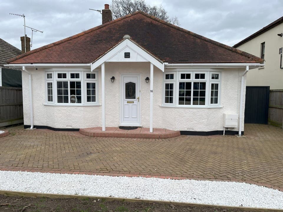 Front of the property, with spacious driveway for parking.