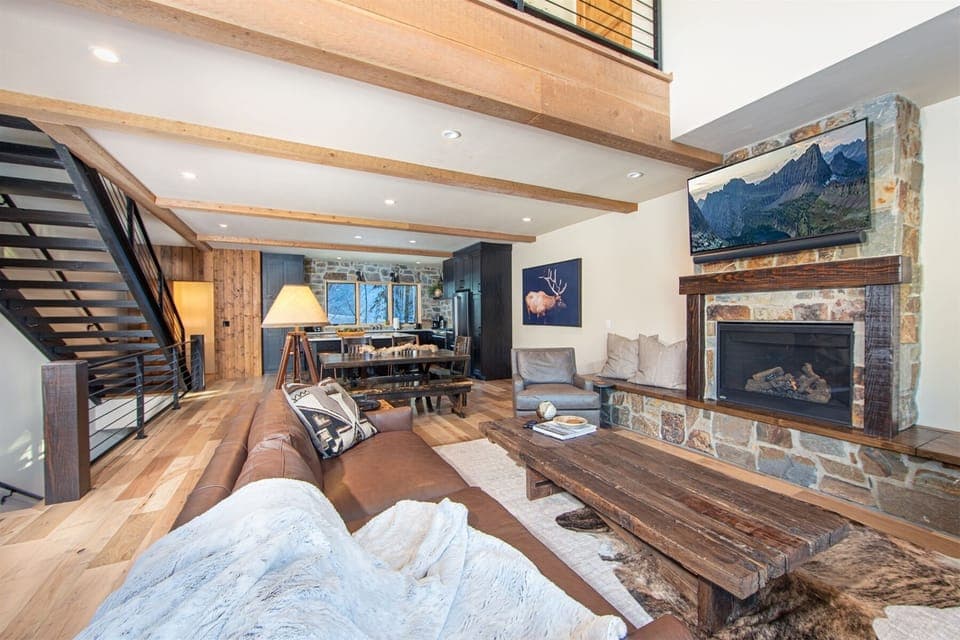 The home's open concept living room, dining room & kitchen provide a beautiful space for your group to connect | Main Level