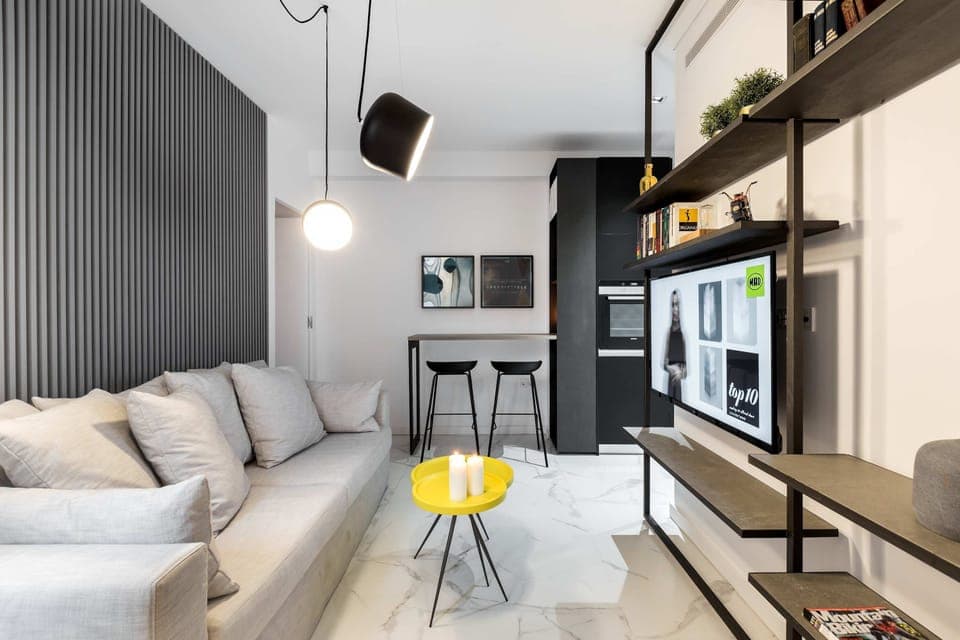 Sleek open-plan lounge with plush sofa, stylish shelving, and perfect walkable city-center convenience nearby.