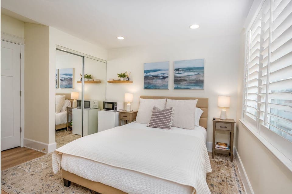 Modern bedroom, stylish Airbnb, cozy retreat, natural light, comfortable bed, beach-inspired, minimalist design, spacious room vacation rental, guest-friendly space, luxury stay, elegant, furnishing, relaxing ambiance, bright and airy.