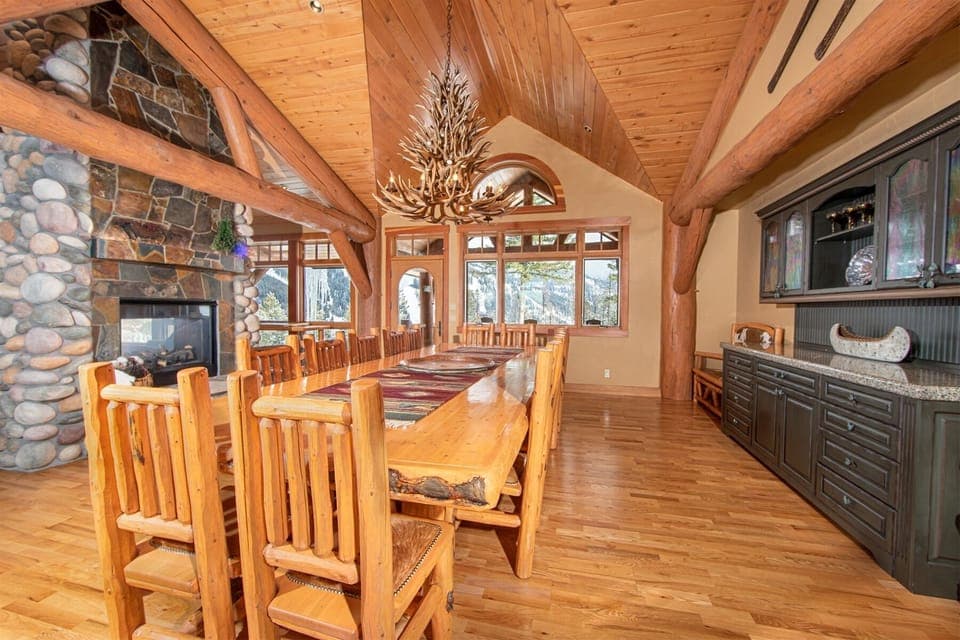 The dining room features custom-built log table with seating for 14 guests | Main Level