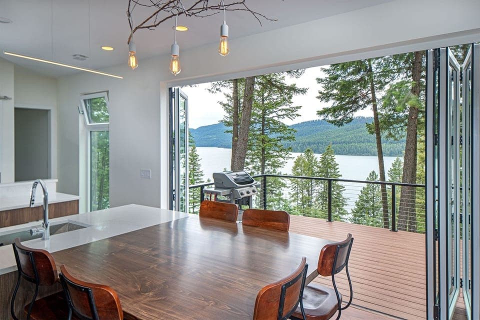 Access the patio from the kitchen and living room, and take in amazing views of Whitefish Lake | Main Floor