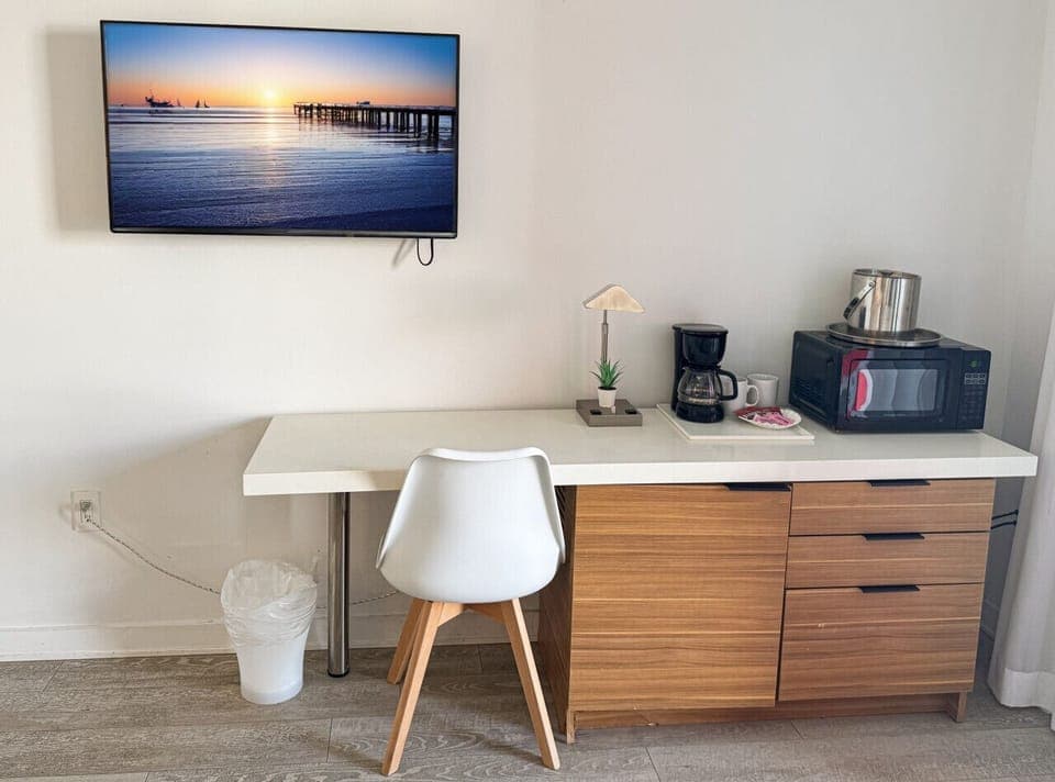 Well-equipped workspace and TV area inside the bedroom.