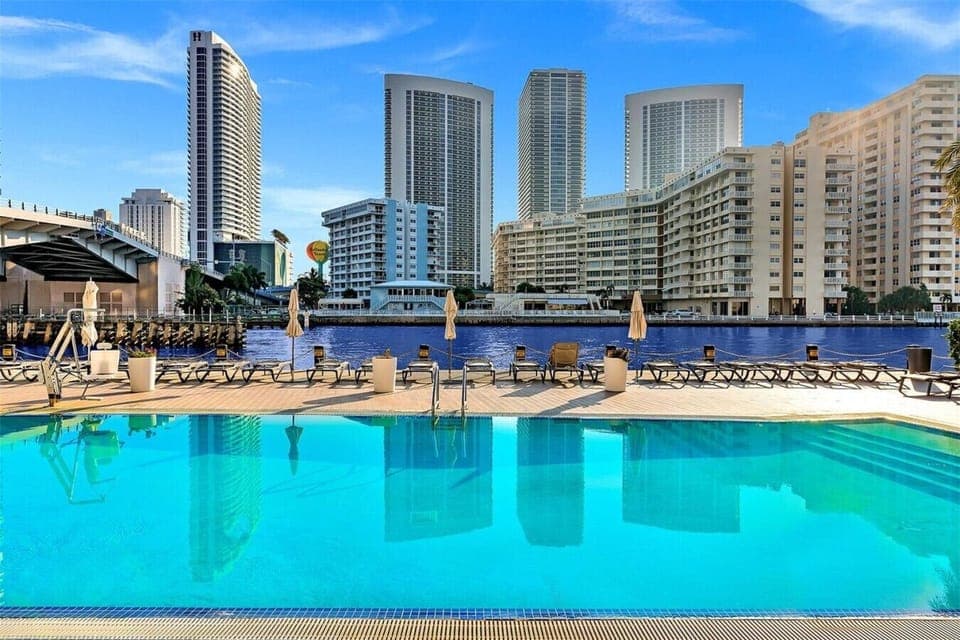 Resort-style outdoor pool surrounded by stunning city views.