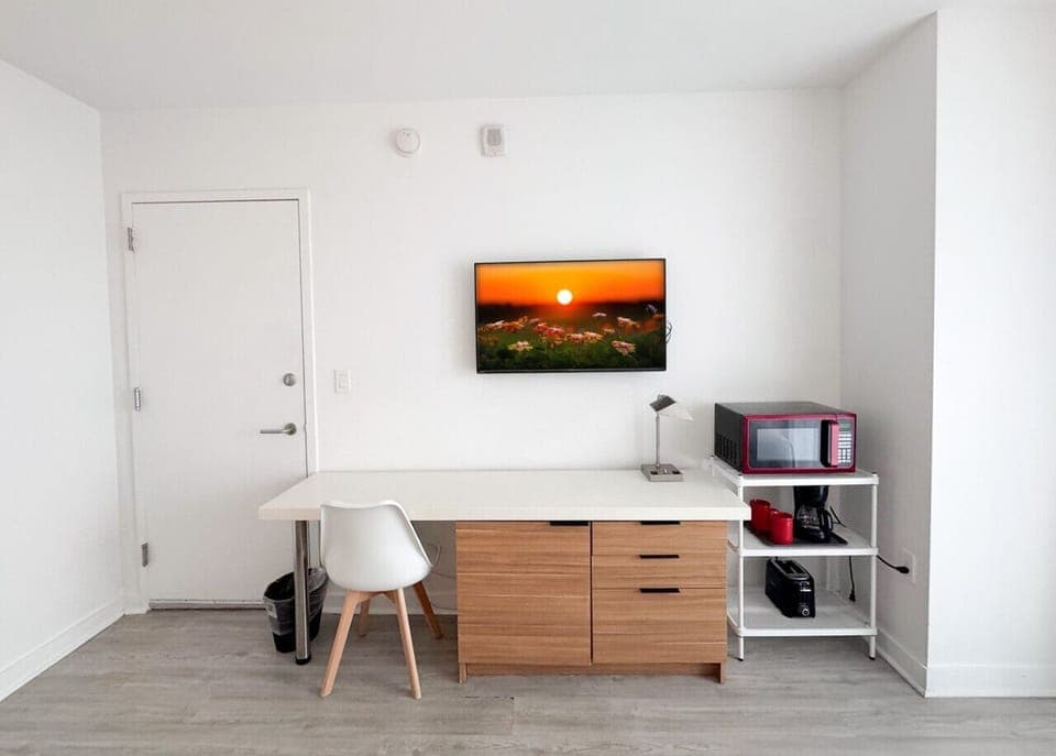 Well-equipped workspace and TV area inside the bedroom.