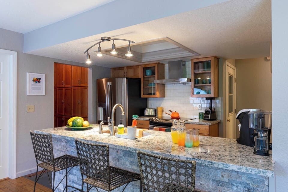 Well-appointed kitchen, including a crockpot, blender, plenty of pots and pans.