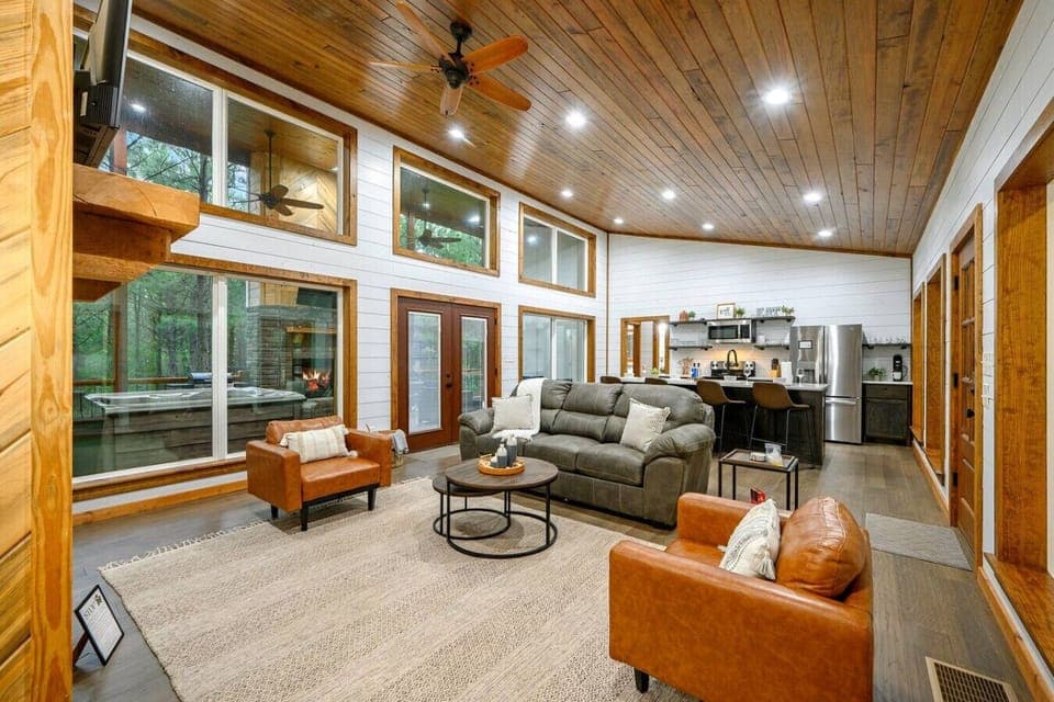 Unwind in this airy retreat with forest views and warm wood tones.