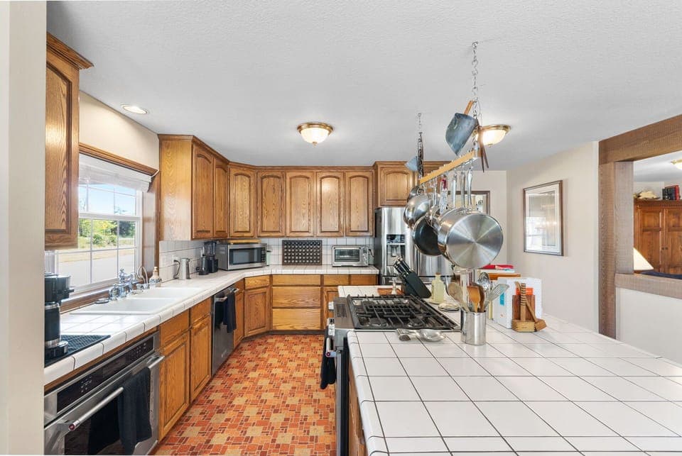 A big beautiful kitchen with top end appliances, coffee, blender, air fryer, etc