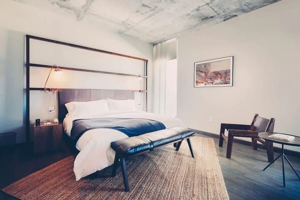 Drift off in a serene king bed with airy light.