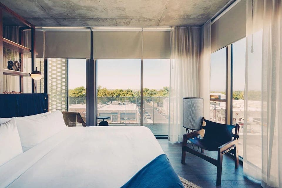 Wake up to skyline views from a sunlit, dreamy bed.