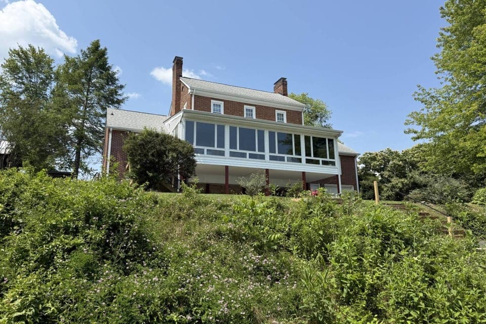 View of the back exterior and steps leading down to the lake