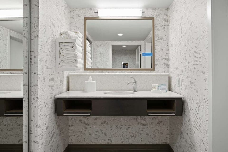 Refresh at a wide vanity with clean towels ready.